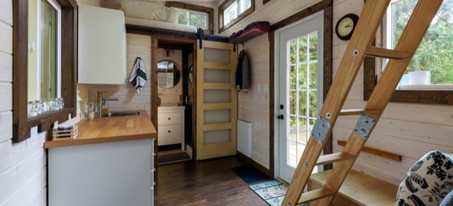 tiny home interior with ladder, windows, and front door