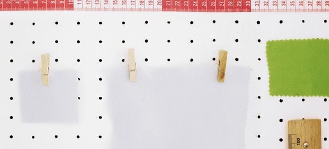 pegboard with craft supplies and rulers