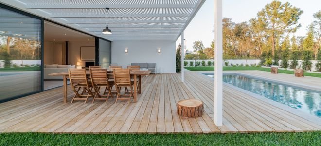 wood floor deck with furniture next to pool