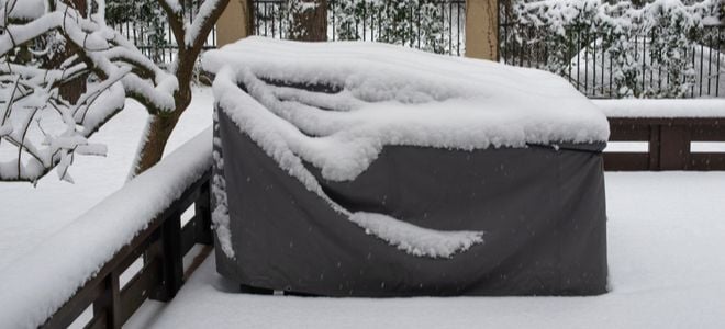 covered furniture in snowy outdoor area