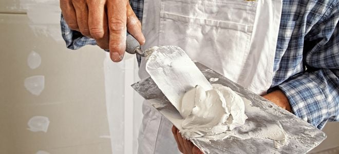 man applying paster patches with scraping tools