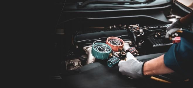 hands using coolant measuring tool to check car heater