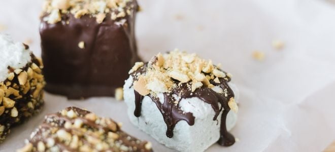 delicious homemade marshmallows dipped in chocolate with crumbled nuts