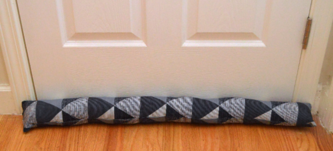 A draft sock against a door. 