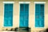 Louvered blue doors on outside of a building