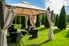 canvas gazebo in landscape with grass and bushes