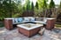 A patio with a brick firepit and bench.