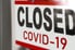 closed sign outside store for covid 19