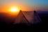 A tent against a sunrise. 