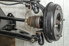 Front suspension members of an older car with new brake drum exposed with spindle, ball joints and steering rack visible