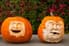 Two pumpkins with creepy faces. 