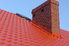 Chimney protruding from a red roof