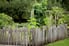 A rustic wooden fence surrounding a garden.