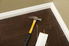 Baseboards with a hammer nearby