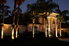 A Florida home at night with landscape lighting.