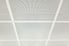 Perforated, white ceiling tiles.