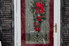 storm door with a wreath on the outside of a house in the snow