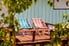 A pair of striped lounge chairs on a sunny wood deck.