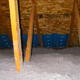 Blue attic baffles, with a foreground of cellulose insulation.