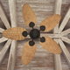 A view looking up at a rustic wood ceiling with a bamboo ceiling fan.