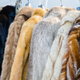 multiple fur coats hanging