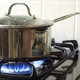 A gas stove with a pot on it.