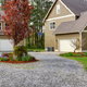 gravel driveway leading to home and garage buildings