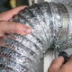 hands tightening dryer vent tube