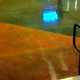 a shiny concrete floor next to stair railings with colorful angular shapes