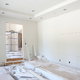 A room under construction with bare, sheetrock walls.