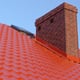 Chimney protruding from red roof