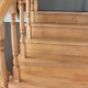 unpainted wooden stairs and railing