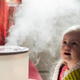 Young girl sitting in front of humidifier