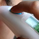 closeup of an ear thermometer in someone's ear