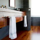 A bathroom with wood cabinets and floors.