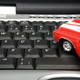 A toy car on a keyboard.