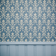 Blue and tan wallpaper on a wall
