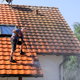 Man sprays a roof