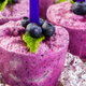 purple homemade popsicles with blueberries