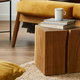 wood cube coffee table in room with natural colors