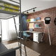 A loft bed in an apartment or dorm room with a brick wall. 