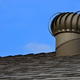 A roof vent against a blue sky.