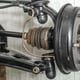 Front suspension members of an older car with new brake drum exposed with spindle, ball joints and steering rack visible