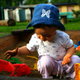 A baby playing in a sandbox.