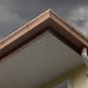 roof and gutter under heavy rain clouds