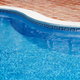 The edge of a clean, in ground pool.