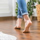 A woman walks on laminate floors.