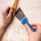 scraping off wallpaper with putty knife
