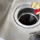 food in a sink over a garbage disposal drain