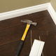 Baseboards with a hammer nearby